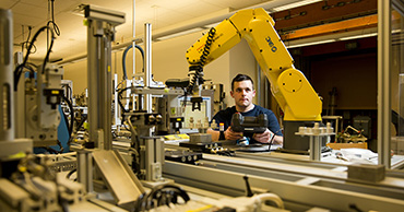 man working with robotics equipment