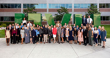 large group of people in front of the uvu sign