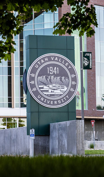 An image of the UVU seal in front of main campus.
