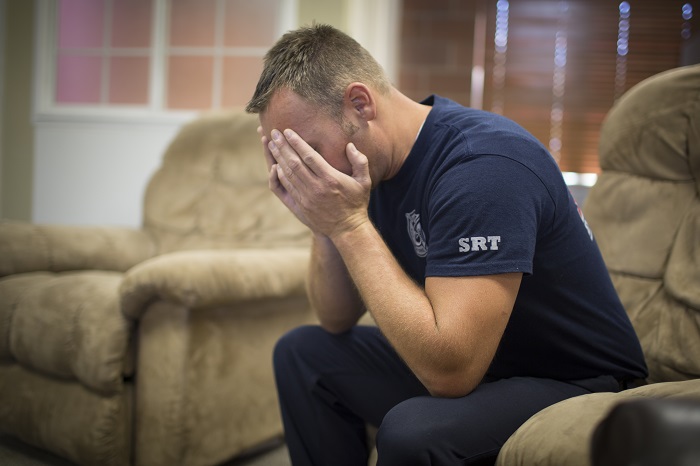 Firefighter sitting with head in hands