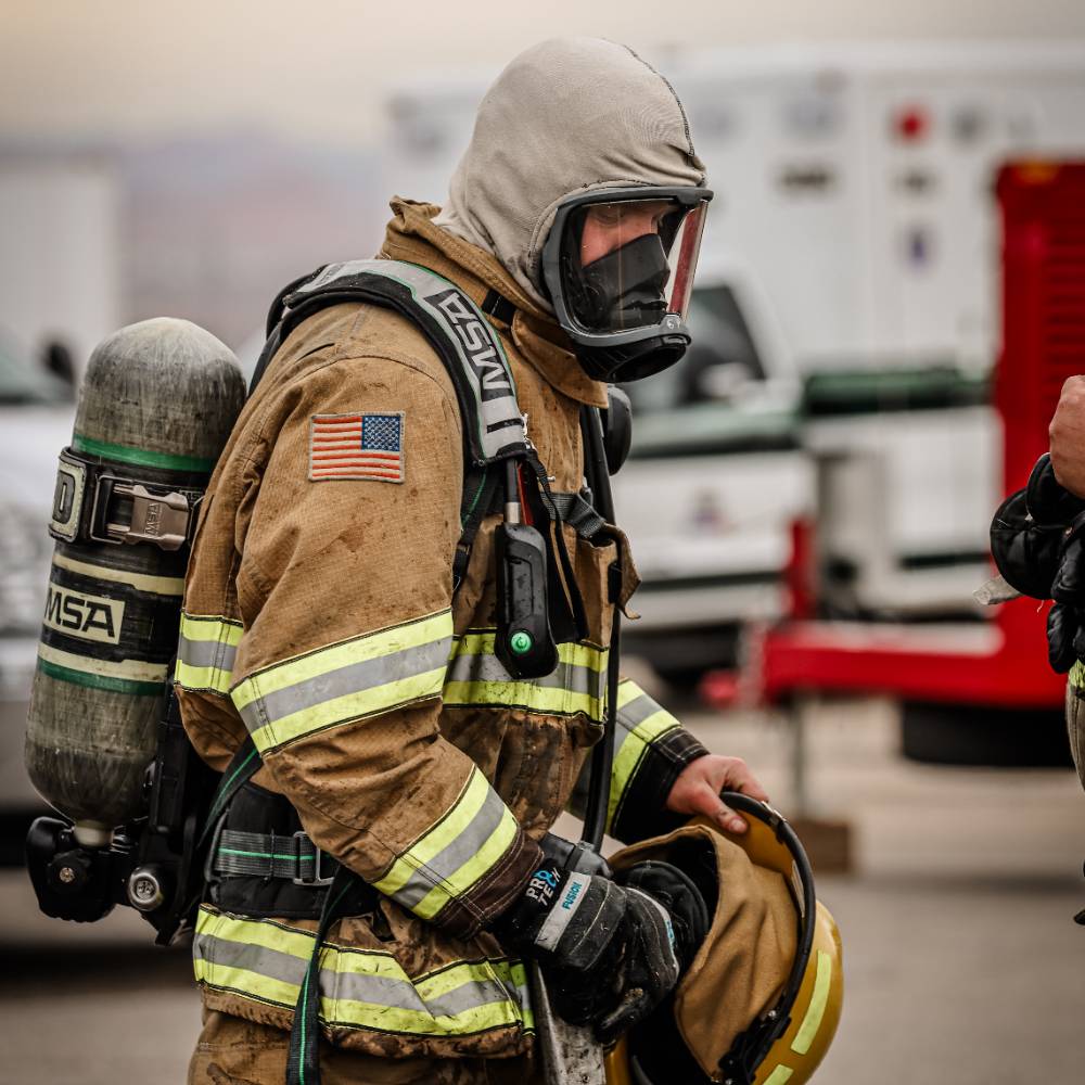 A female health professional rests her hand on a male patients shoulder