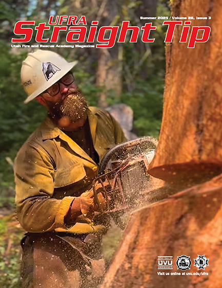 magazine cover firefighter cutting with chainsaw