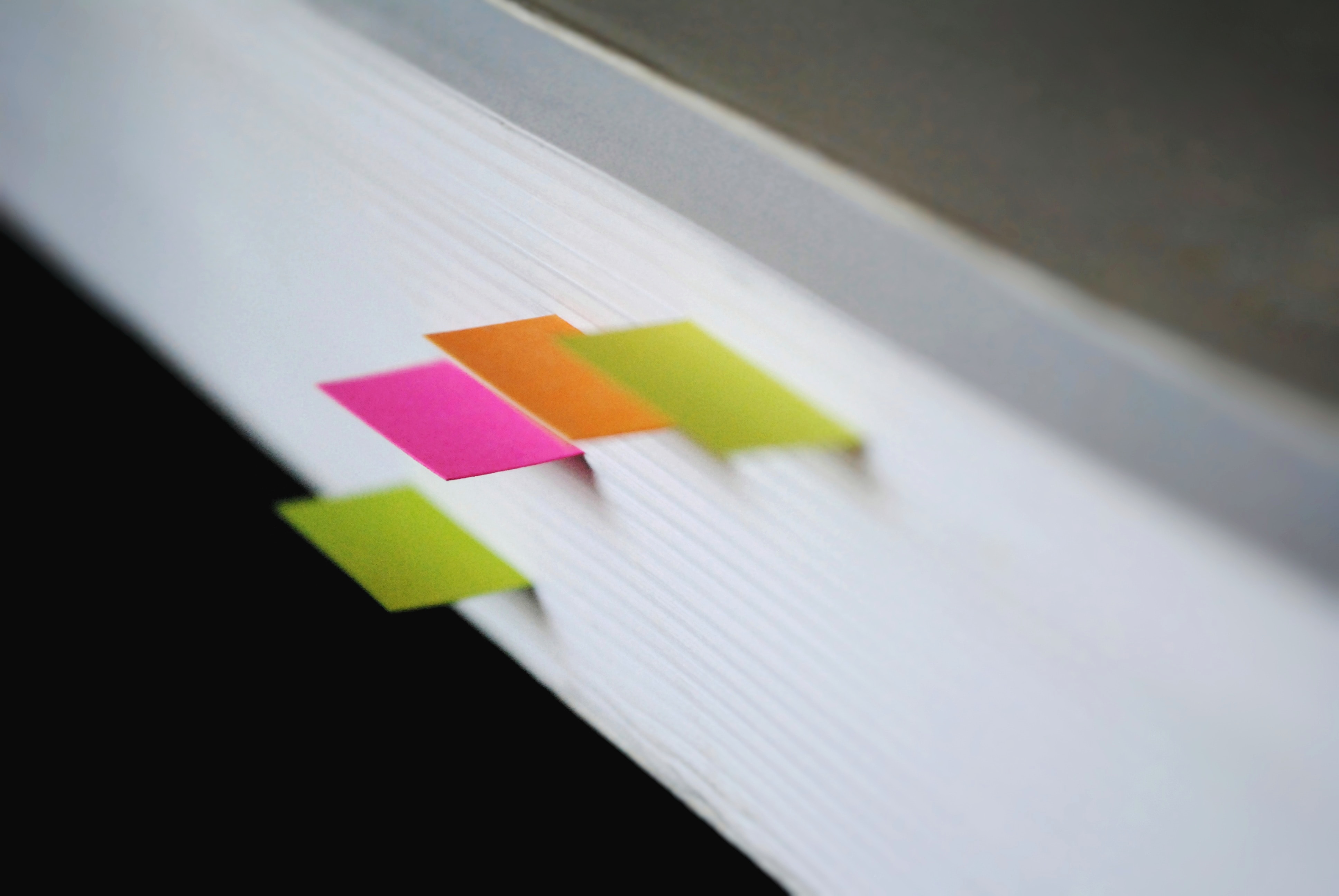 colorful tags marking place in stack of paper