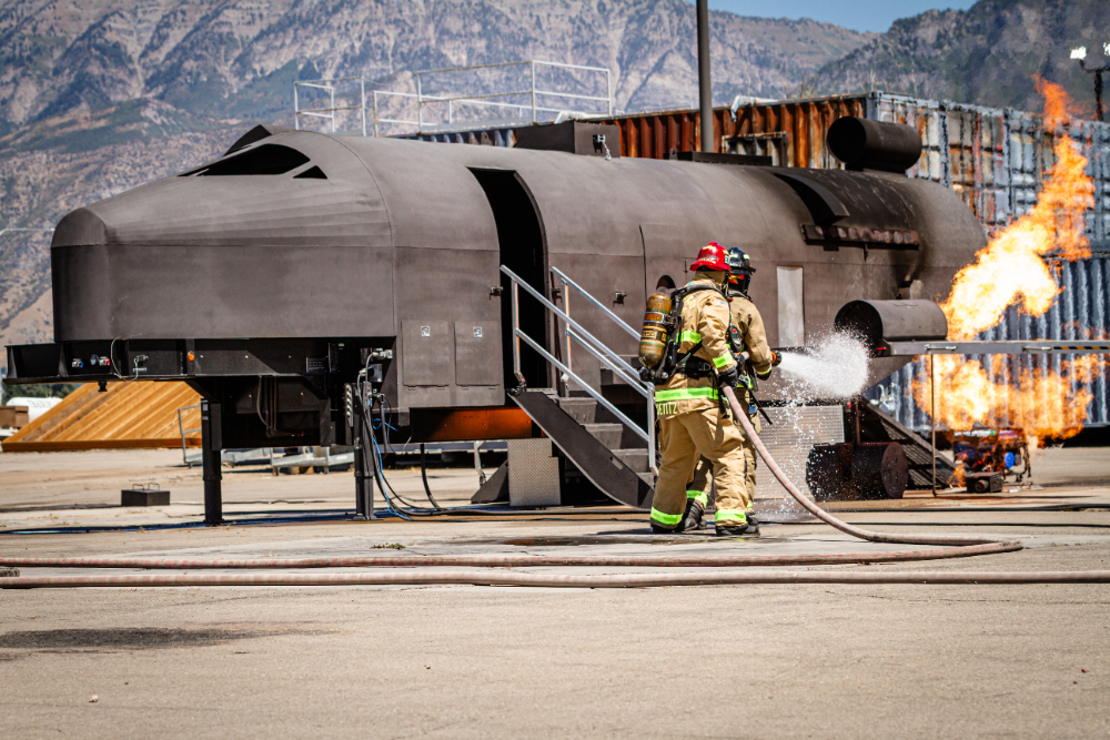firefighters spraying a fire hose