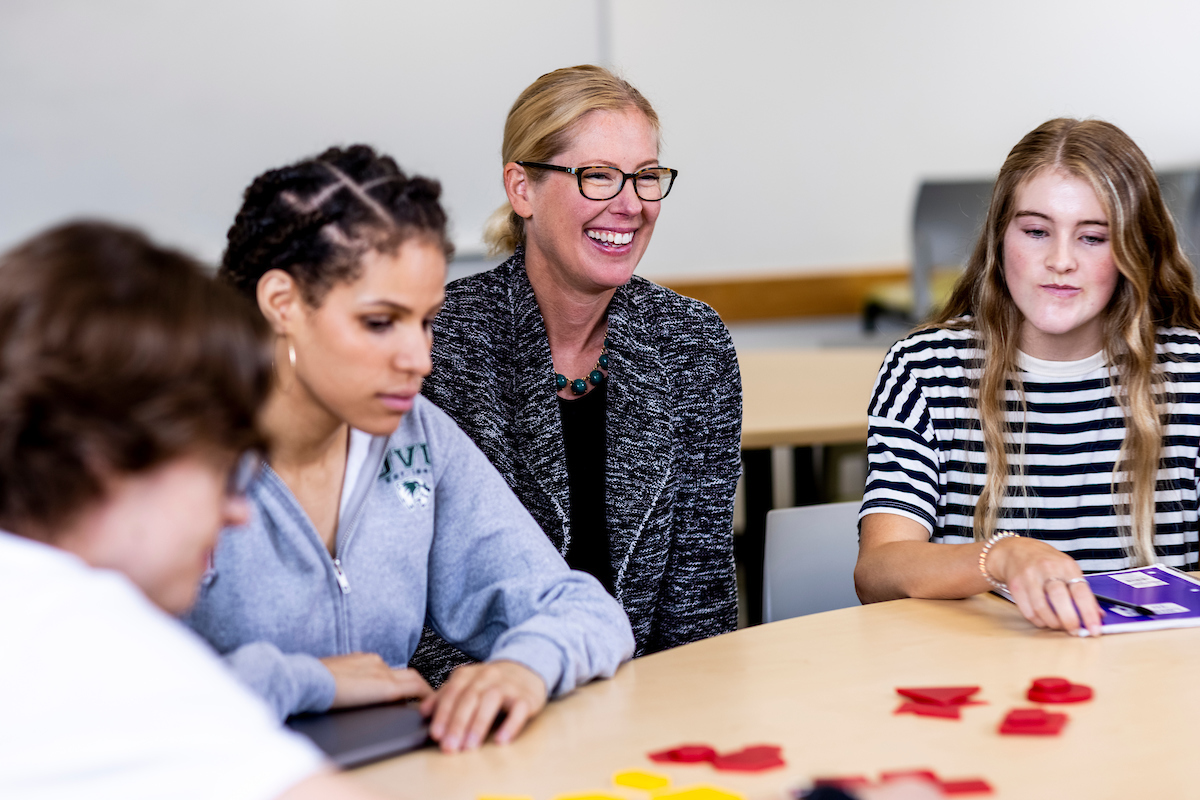 Image of a professor helping their students