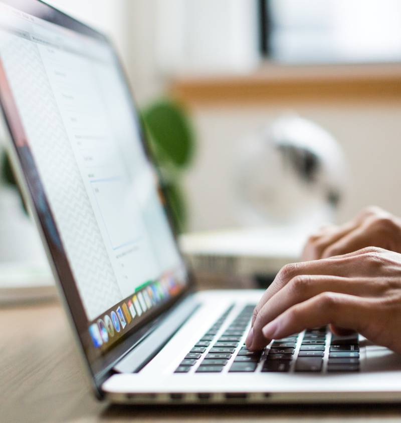 Image of someone typing on a laptop