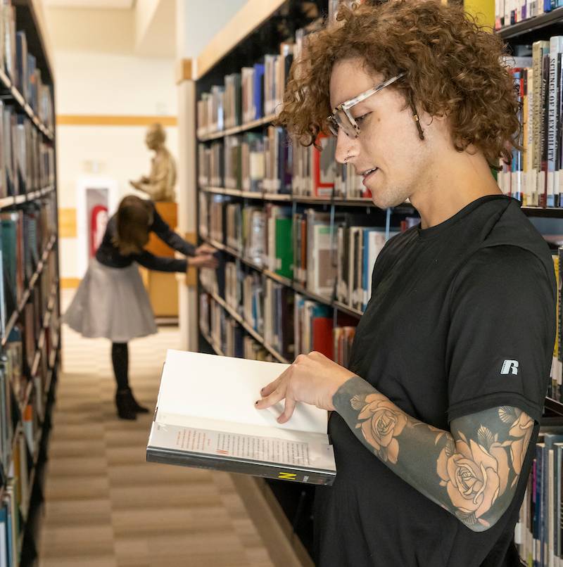 Image of a student reading a book