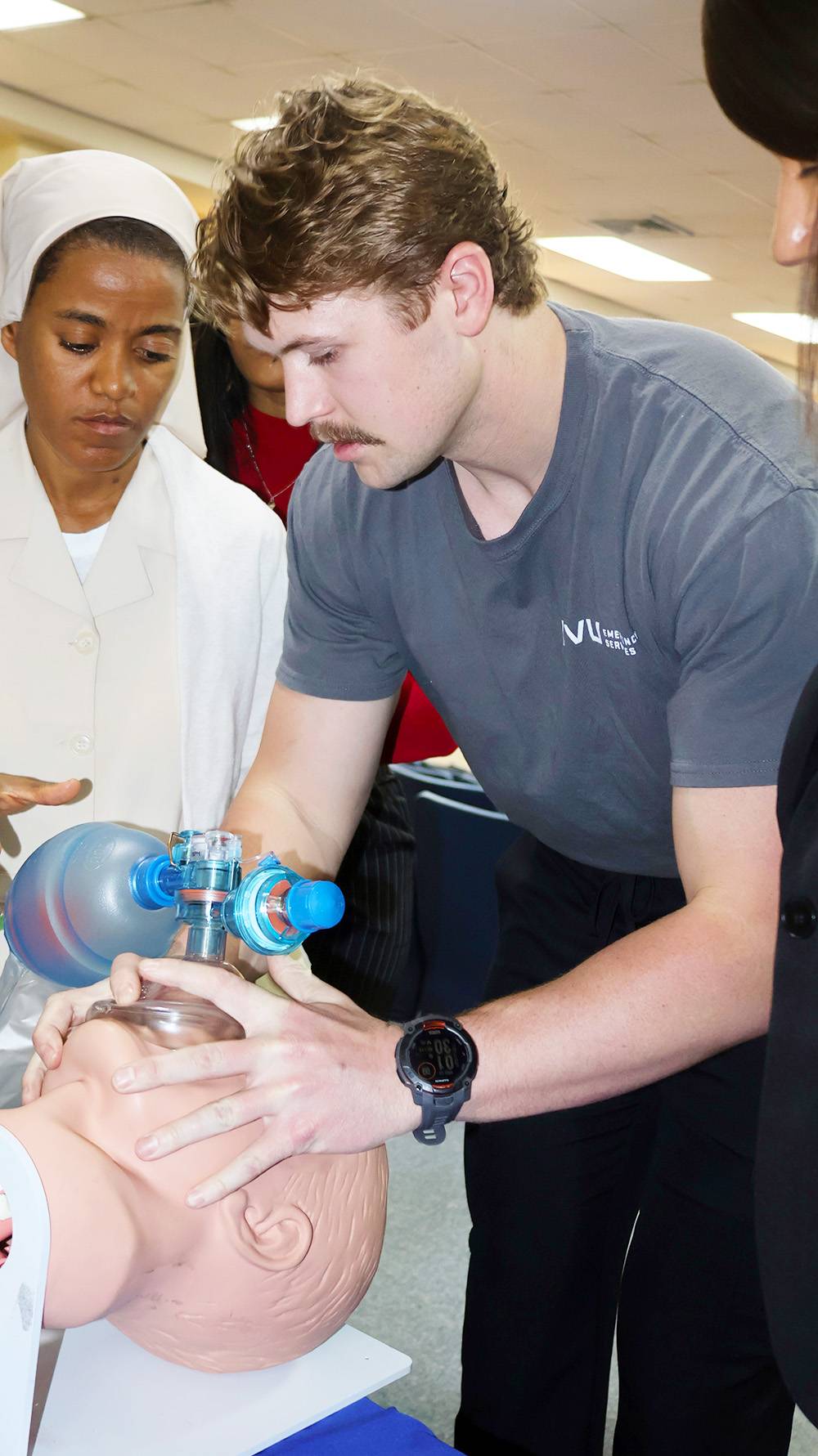 EMS student teaching airway management on mannequin