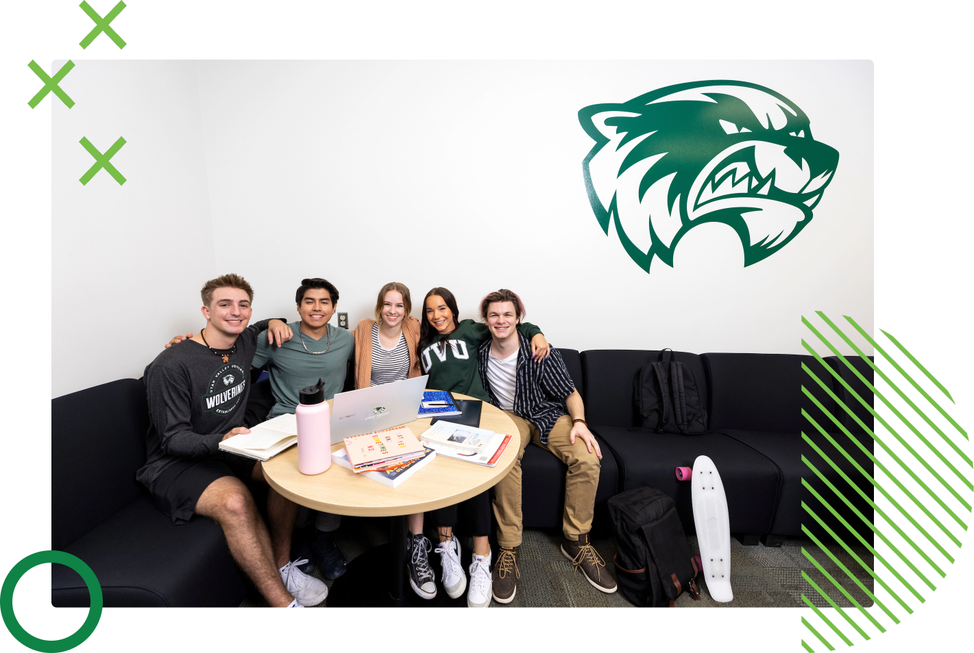 group shot of students huddled together at a table