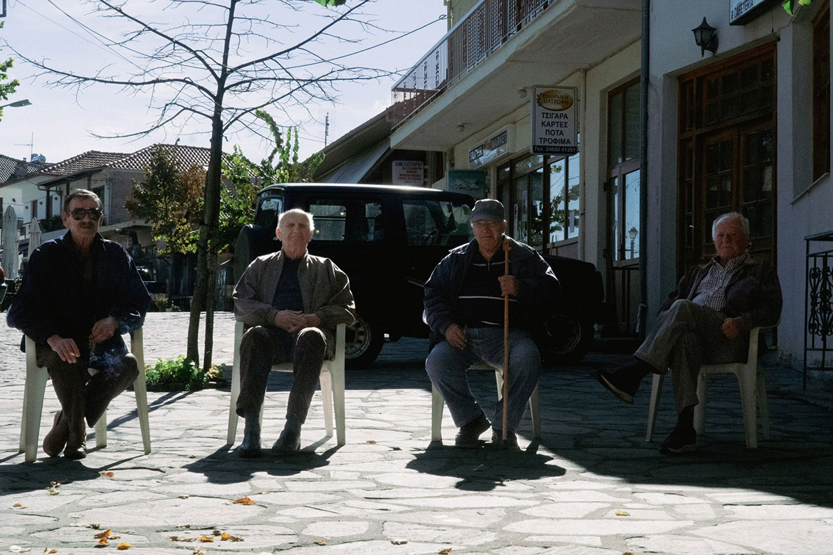 4 Gentlemen from greece in a line sitting down