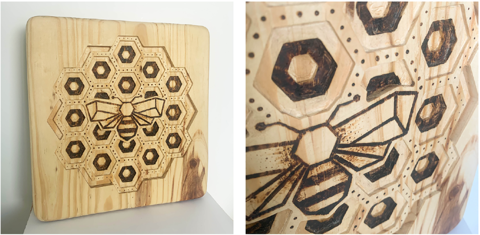 Honeybee design carved into a wooden plaque