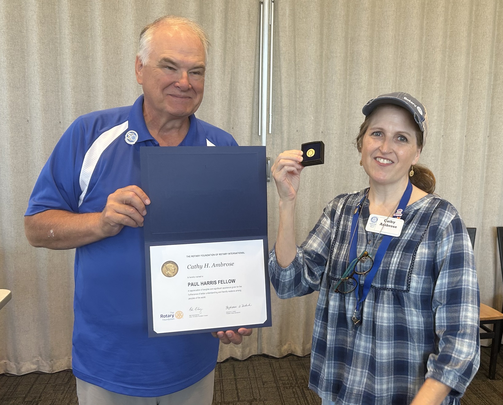 President of the Orem-Lindon Rotary Club, Cathy Ambrose, receiving her award from  Clark Merkley