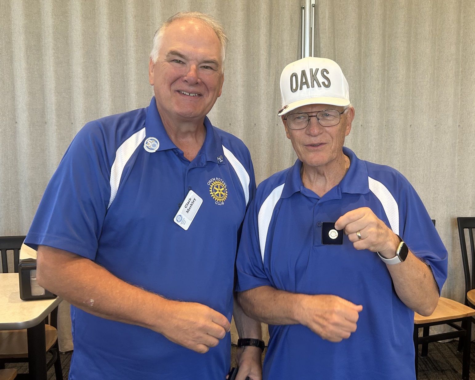 Rotarian D.J. Smith is presented with a Paul Harris Award with seven rubies by Clark Merkley