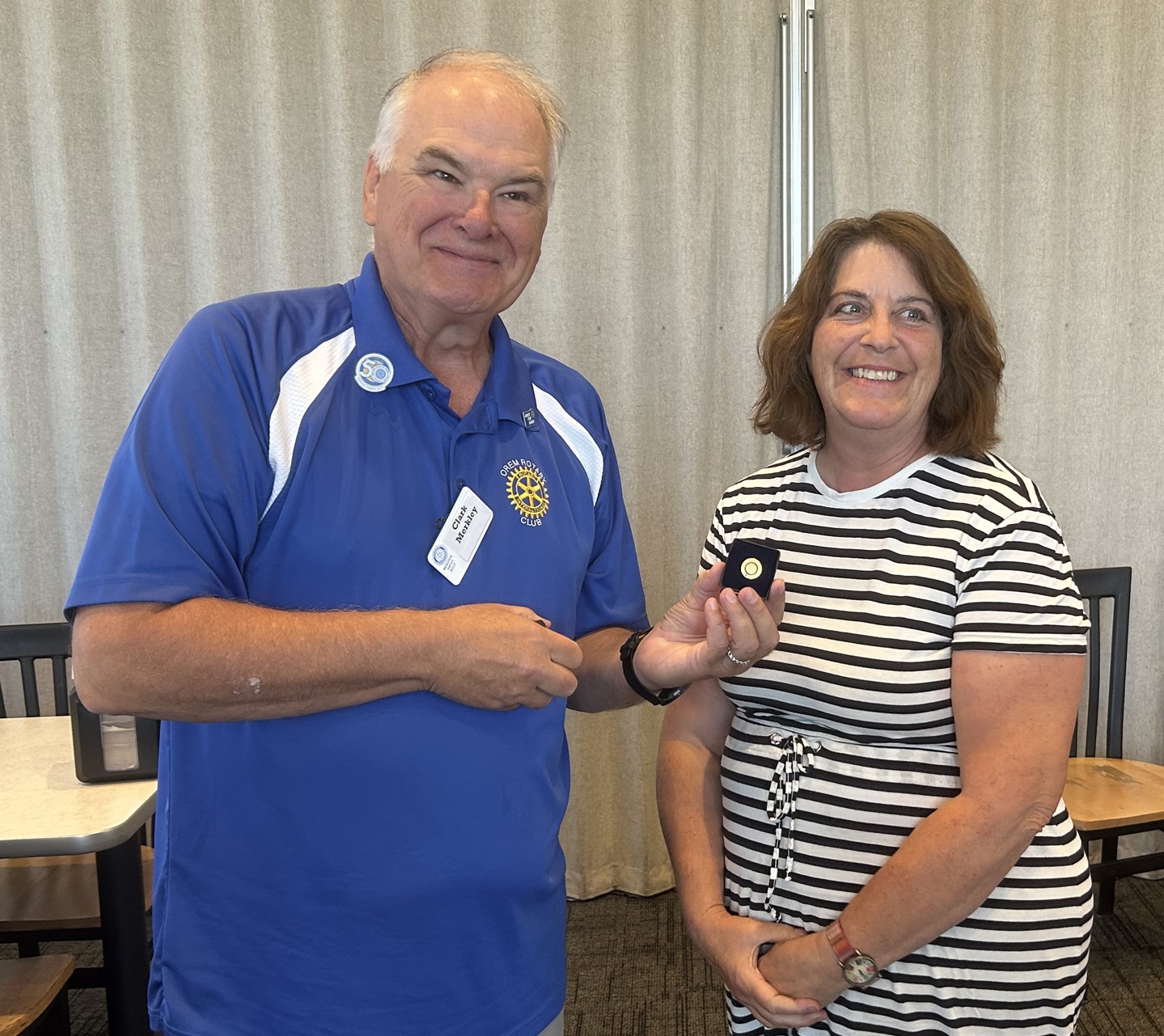 Rotarian  Cherise Armstrong receiving her award from  Clark Merkley