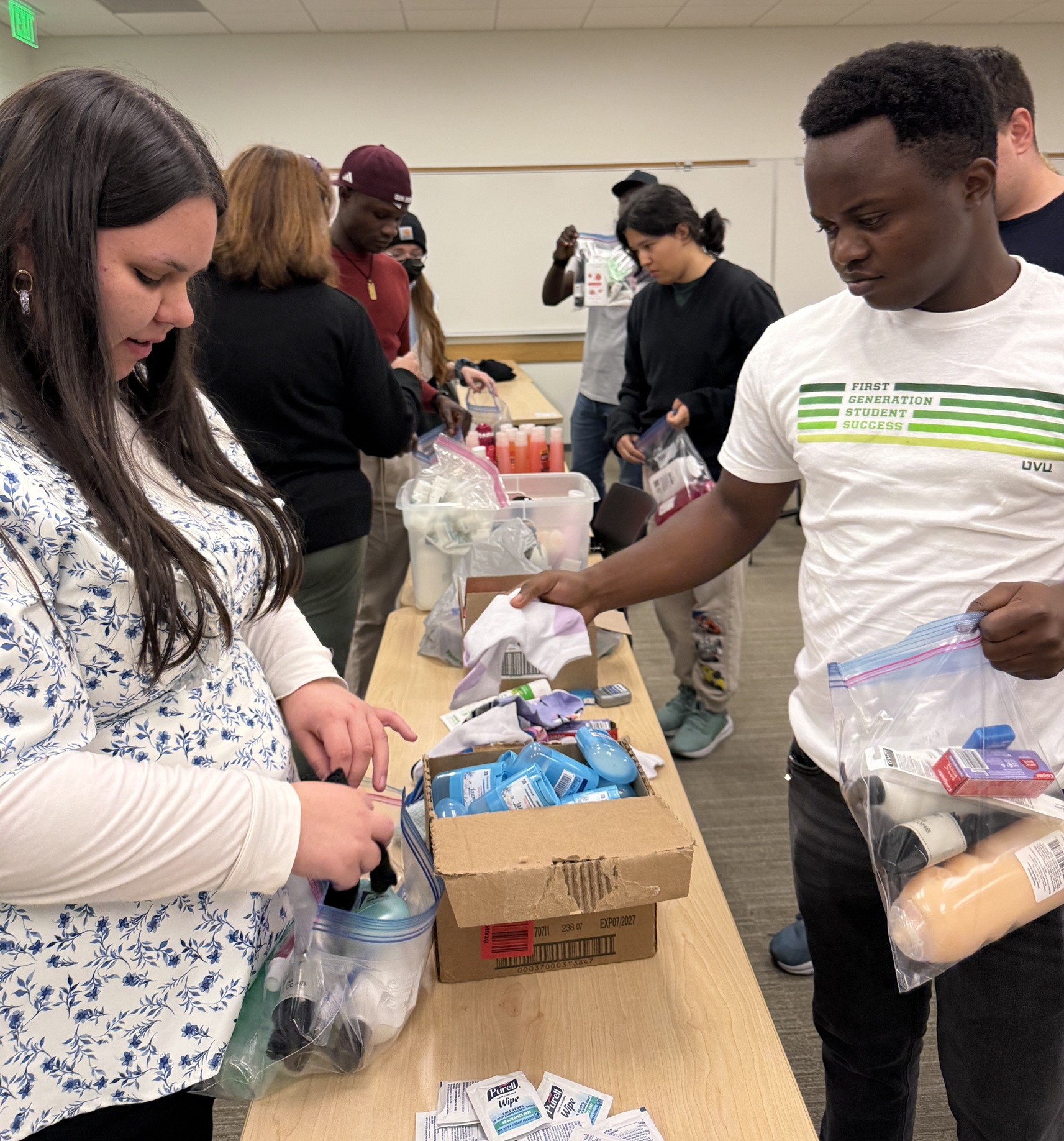 Natalia Figueroa and Rowland Kabongo working on the hygiene kits.