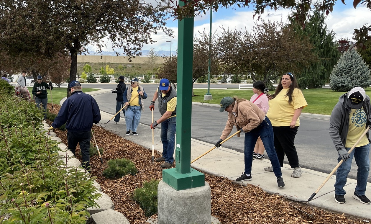 UVU Rotaractors Are Spreading the Mulch Across a Garden Area