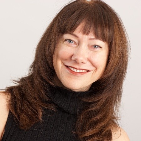 Woman with brown hair smiling with red lipstick