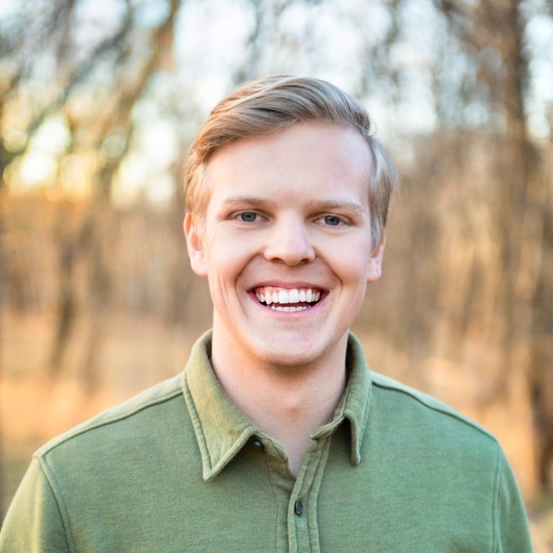 Young man with blonde hair smiling