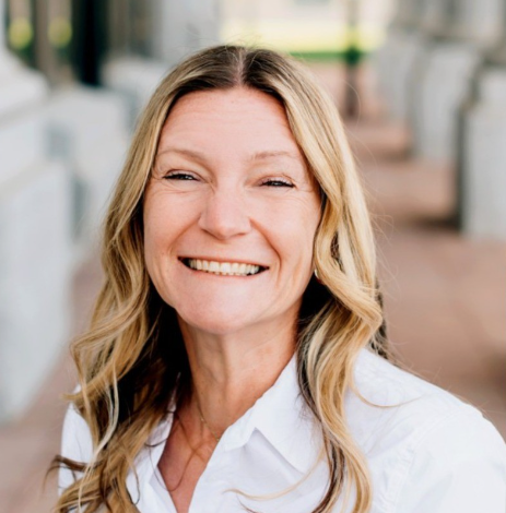 white woman with blone hair smiling gleefully 