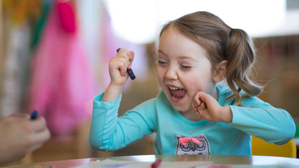 child playing happily at the UVU Wee Care Center