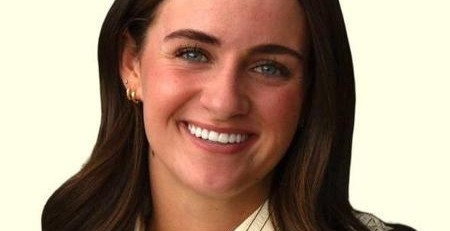 Image of Ashlyn Nipko smiling with a light yellow background
