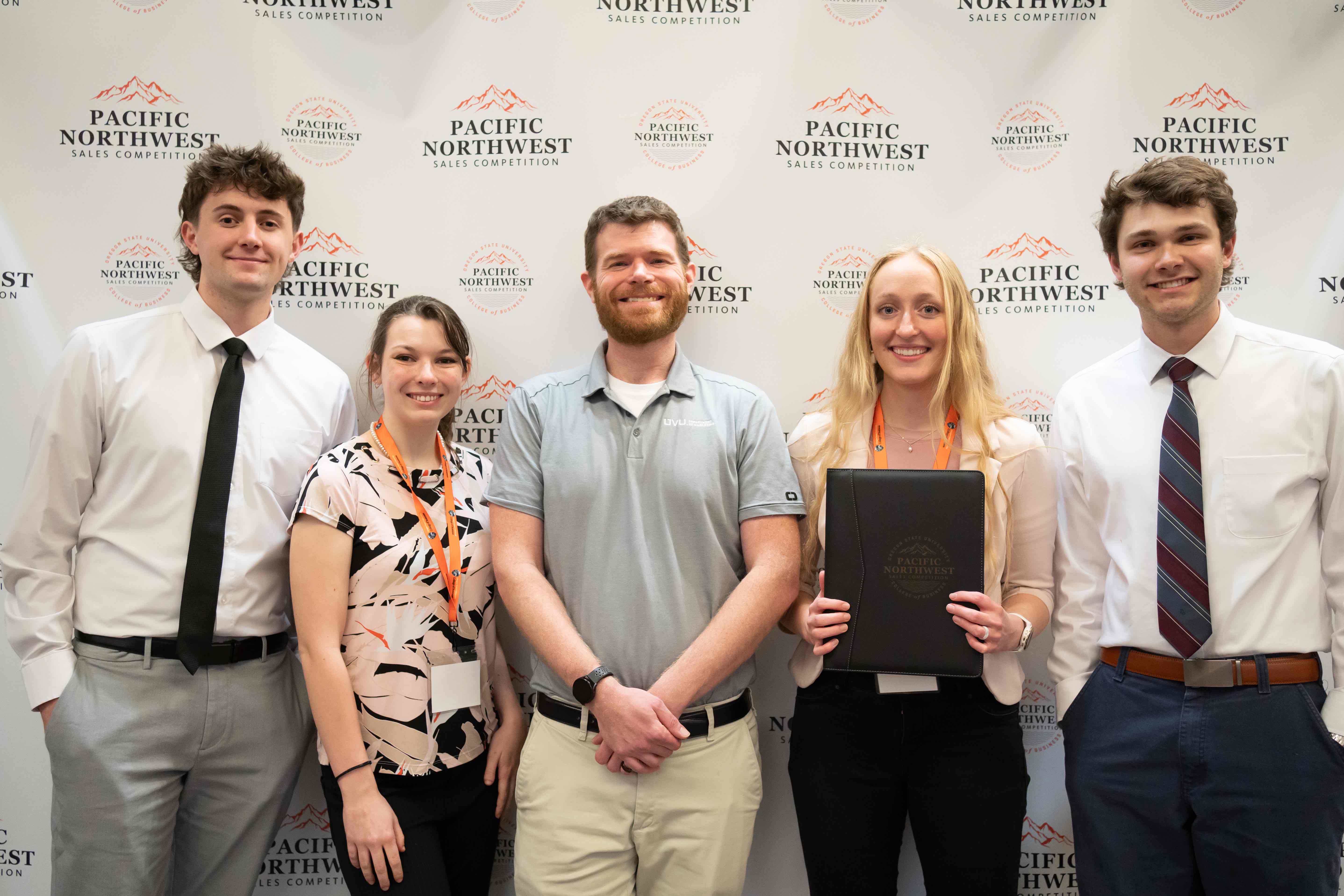 2025 Team of UVU PNWSC students posing for a photo in front of a branded backdrop