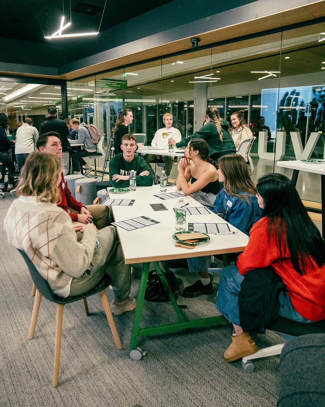 Students talk and collaborate in small groups at a UVU Marketing Association event.