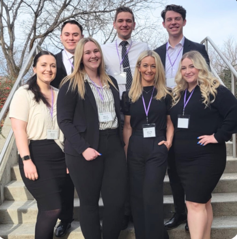 UVU's SHRM Competition Team from 2023 standing and posing for a group photo on a staircase outside