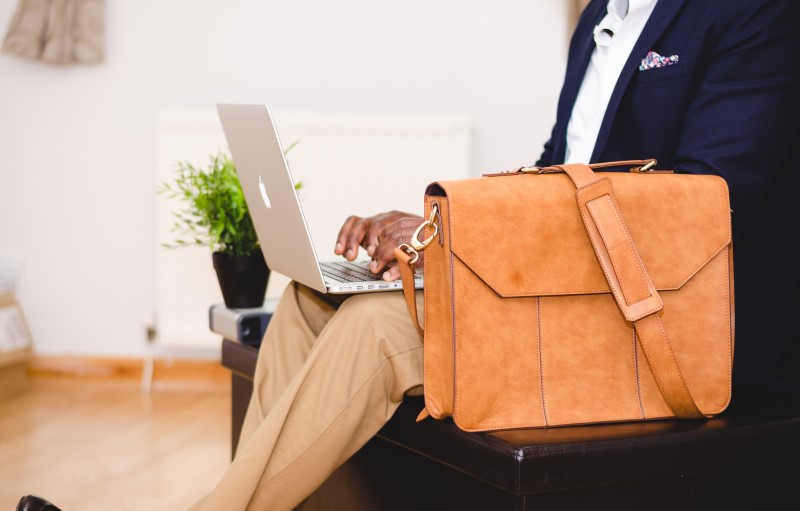 man with briefcase on laptop