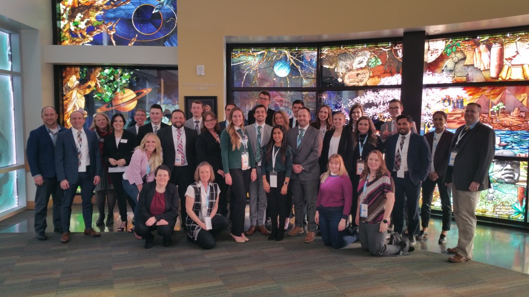SHRM members posing for a photo in front of stained glass