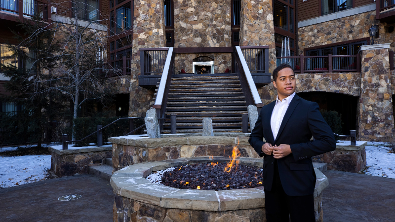 WARM student in professional attire at a luxury resort entrance