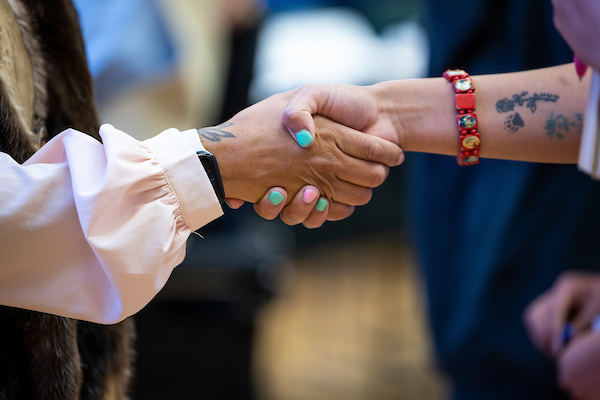 a woman sits at a computer