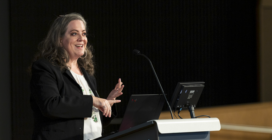 a woman speaking to a crowd