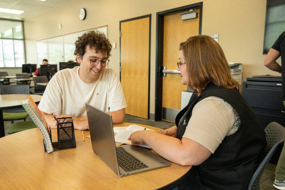 A tutor helping a student at the Writing Center